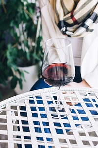 Lady with a glass of red wine in a wine shop photo