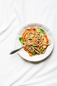 Spaghetti with fresh tomatoes and basil leafs photo