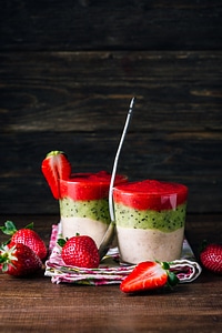 Smoothie from banana, kiwi, and strawberry on a wooden background