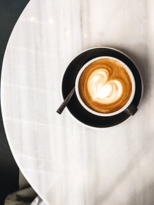 Coffee with milk with hearty latté art photo