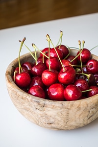 Fresh cherries in a wooden bowl photo