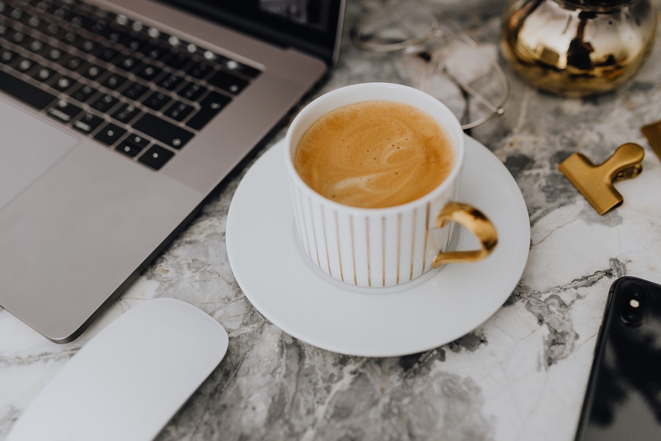 Coffee in a white cup on a marble desk photo