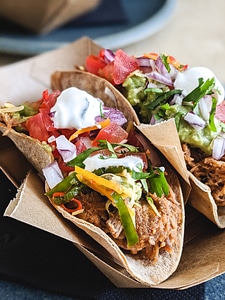Tacos with pulled pork, fresh vegetables and cream photo
