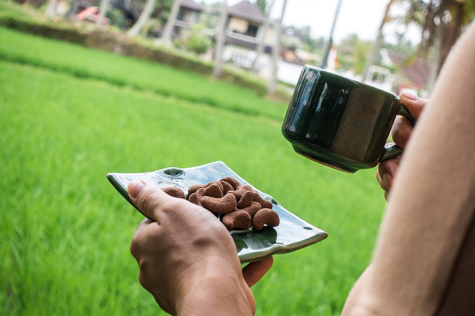 Chocolate coated nuts with a cup of coffee