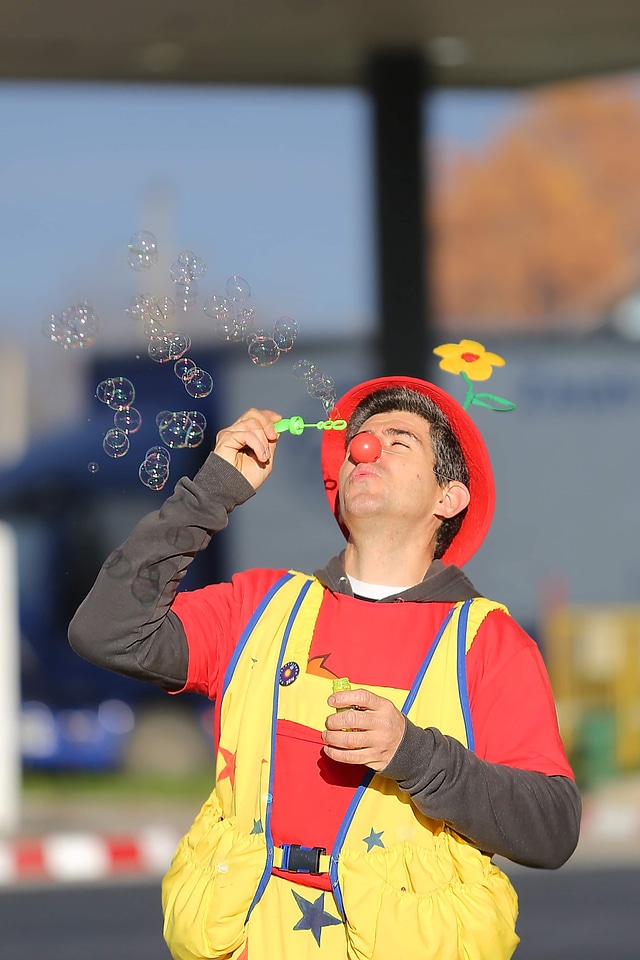 Clown blowing bauble