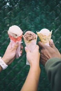 Hands Holding Ice Cream Waffle Cone photo