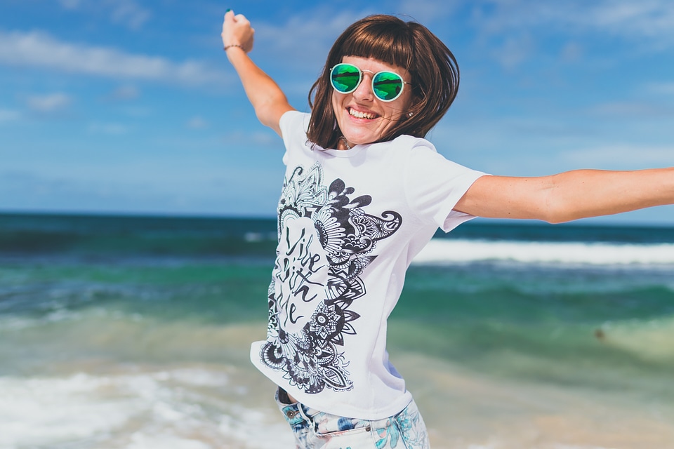 Young Woman Smiling on Seashore