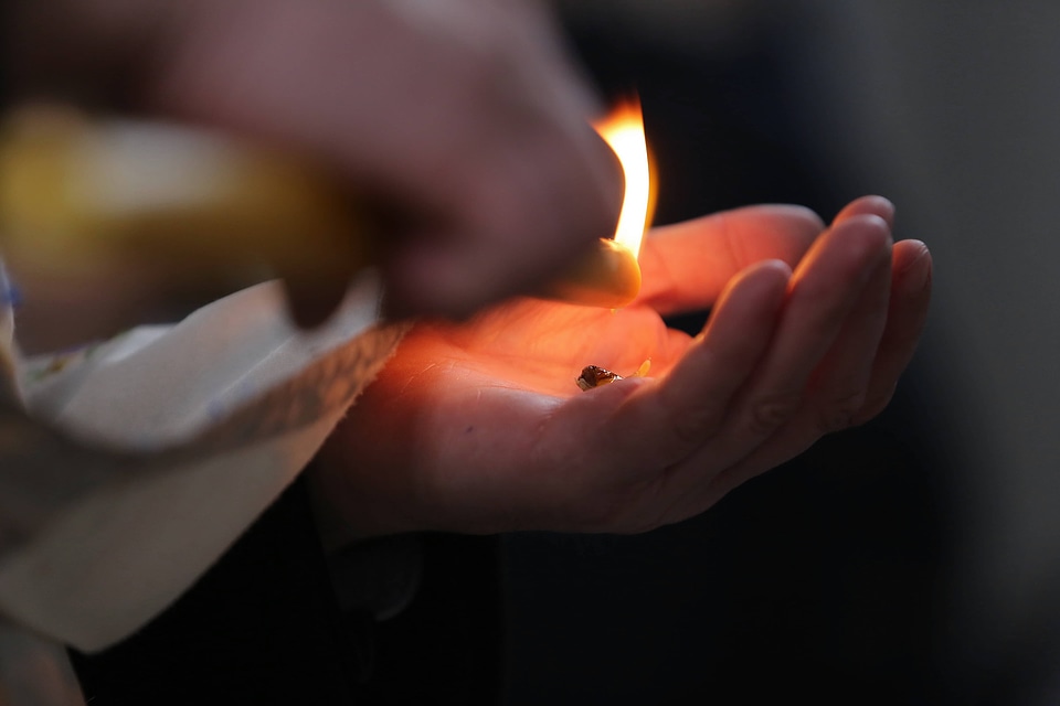 Candle hands close-up