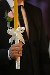 Groom holding candle