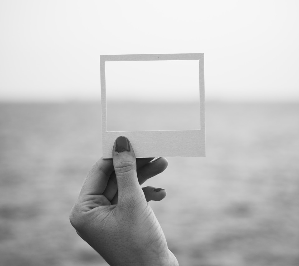 Female Hand Holding Empty Frame