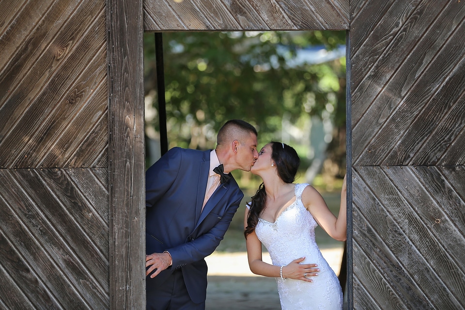 Kiss bride groom photo