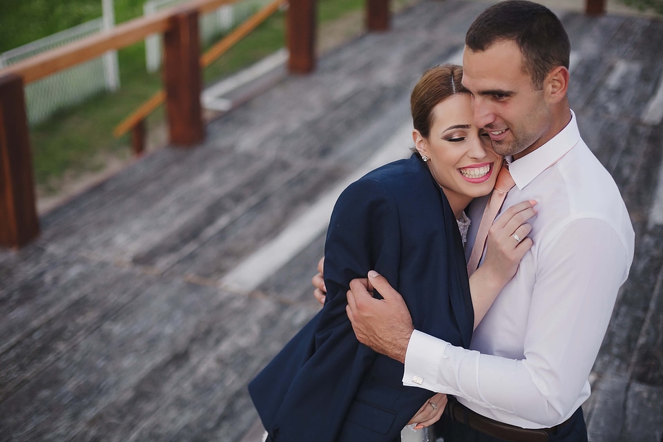 Hugging businesswoman businessman
