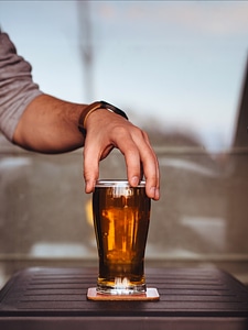 Man Holding Glass of Beer photo
