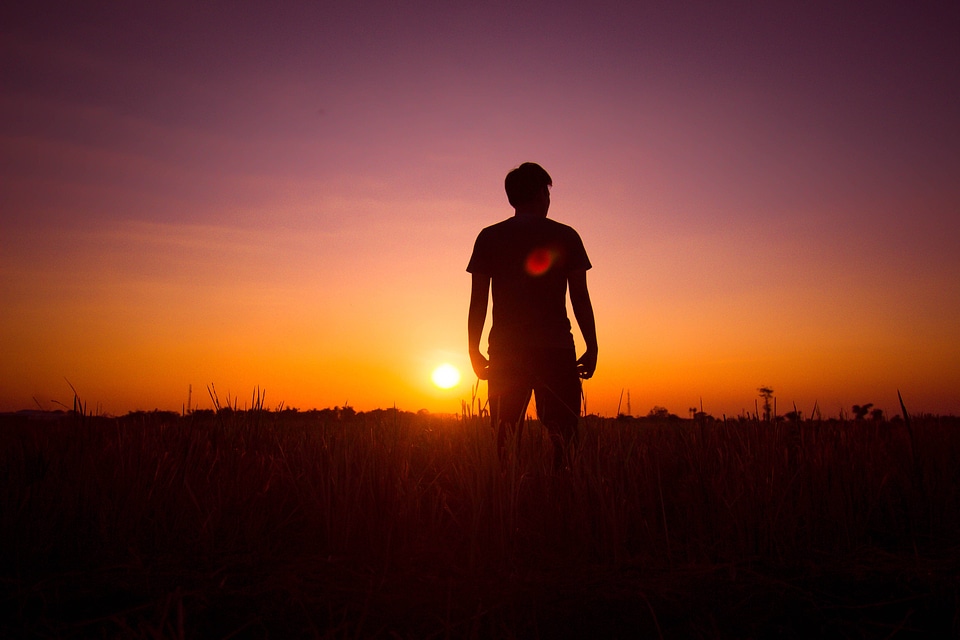 Silhouette sunset man