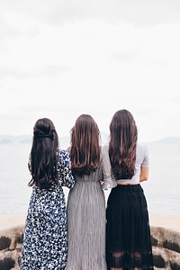 Back View of Three Brunettes in Long Dresses photo
