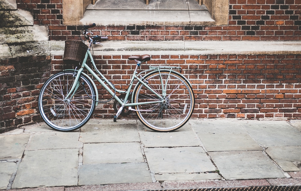 Vintage Bike with a Basket Against a Red Bricks Wall photo
