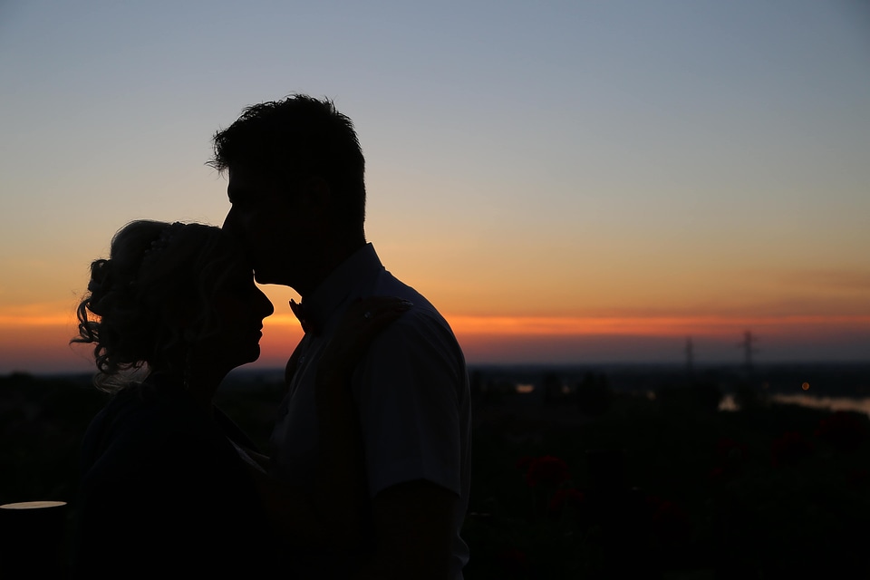 Backlight woman kiss