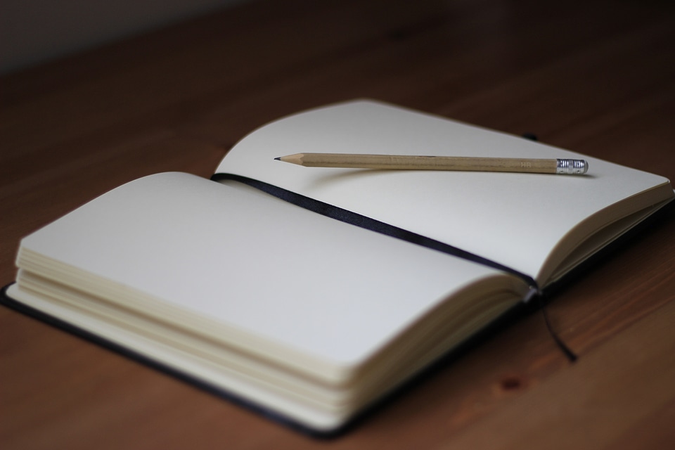 Blank Notebook with Pencil on Desk Background photo