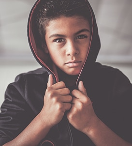 Portrait of Boy Looking at Camera with Serious Facial Expression photo