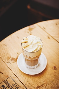 Coffee with Cream and Bananas on Wooden Table photo