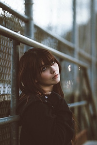 Young Woman Lean on Fence photo