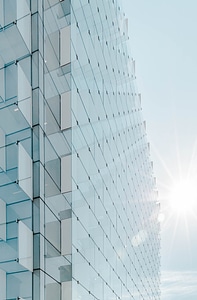 Glass Facade of Modern Office Building with Glare Reflection photo