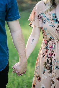 Closeup of Cute Couple Holding Hands While Walking photo
