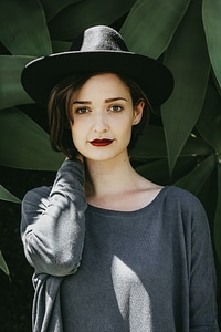 Girl Wearing Black Hat Standing and Looking in the Camera photo