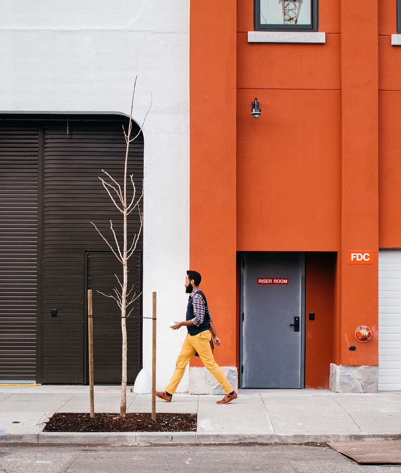 Man Walking Through a Orange Wall photo