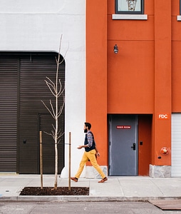 Man Walking Through a Orange Wall photo