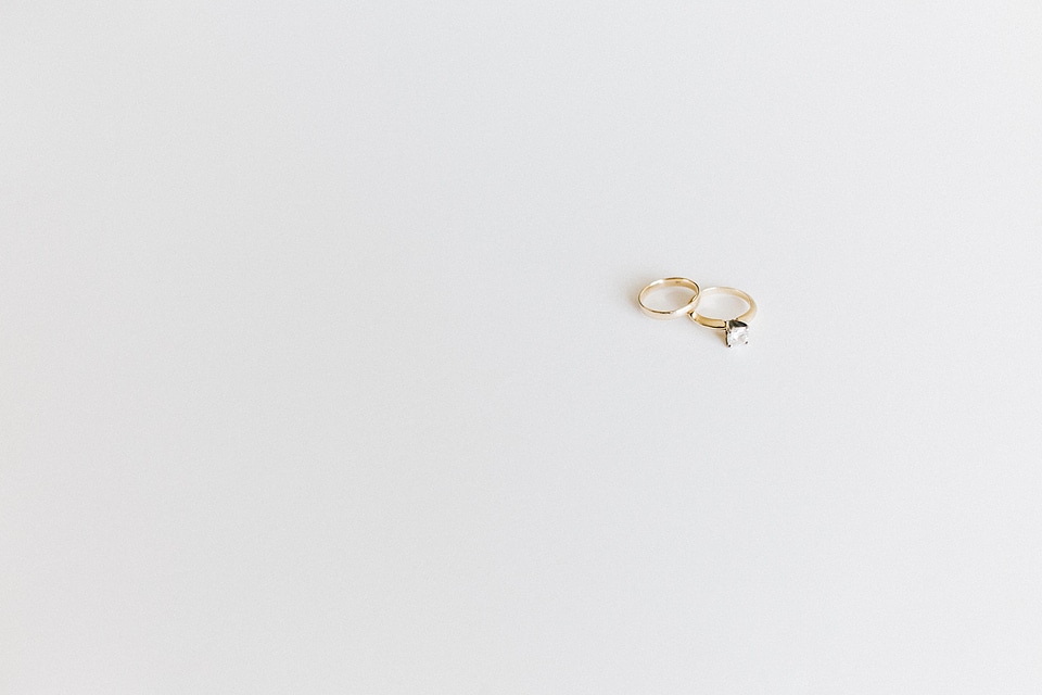Wedding and Engagement Gold Rings against White Background photo