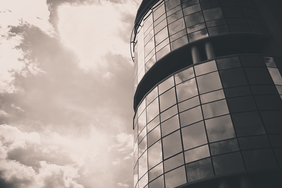 Glass Facade of Office Building Reflecting Clouds