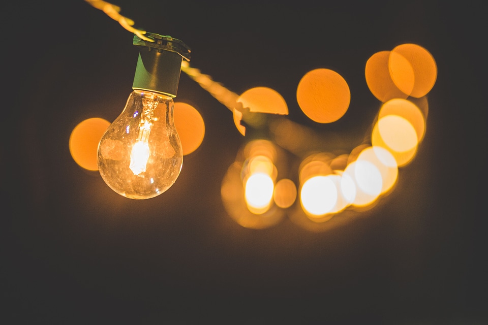 Stream of Bulbs Hanging in Darkness