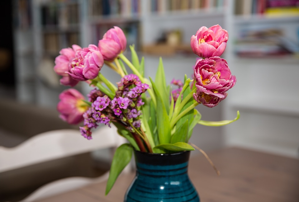 Pink Tulips Bouquet in Vase on Wooden Table photo