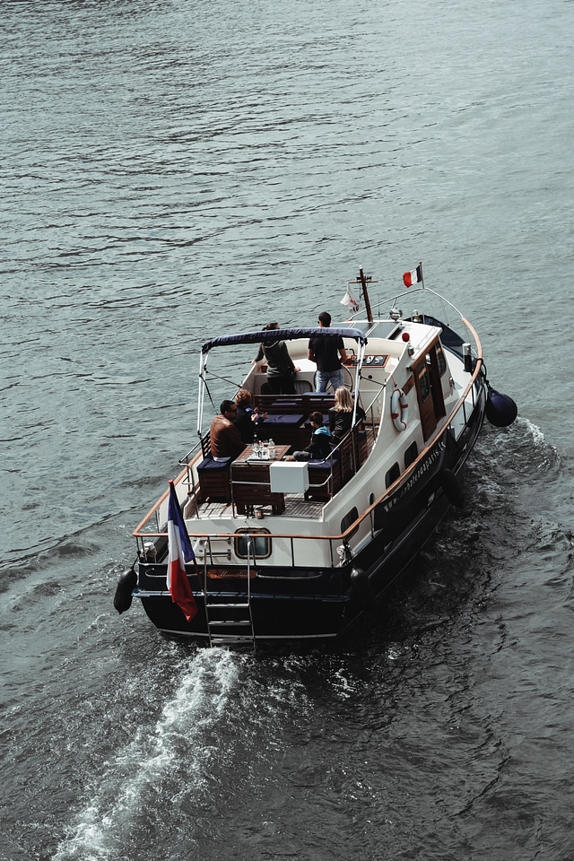 Group of Friends in a Charming Boat Floating on a River