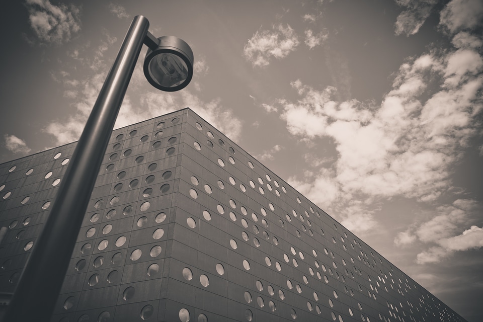 Black Modern Building with Round Windows and City Lamp
