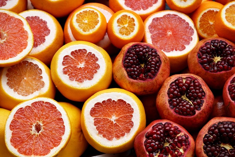 Citrus Fruits Half Cut Orange, Grapefruit, Pomegranate photo