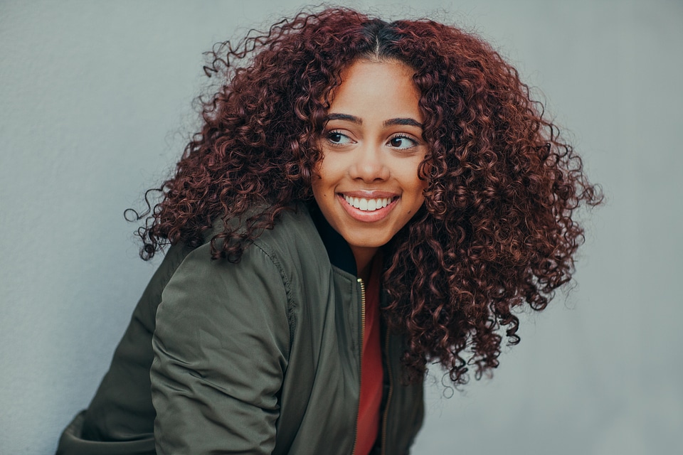 Portrait of Young Woman with Beautiful Curly Hair