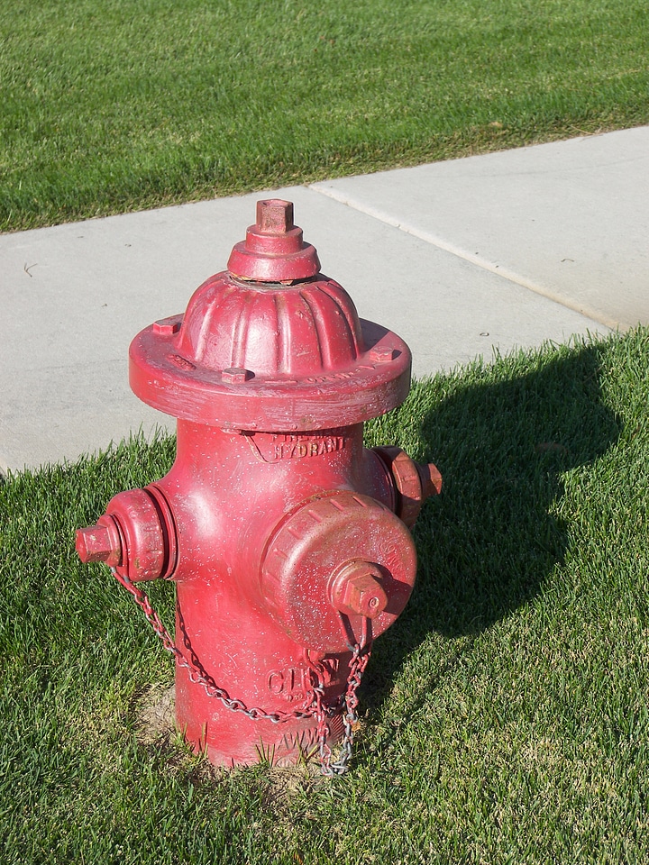 Red extinguisher sidewalk photo