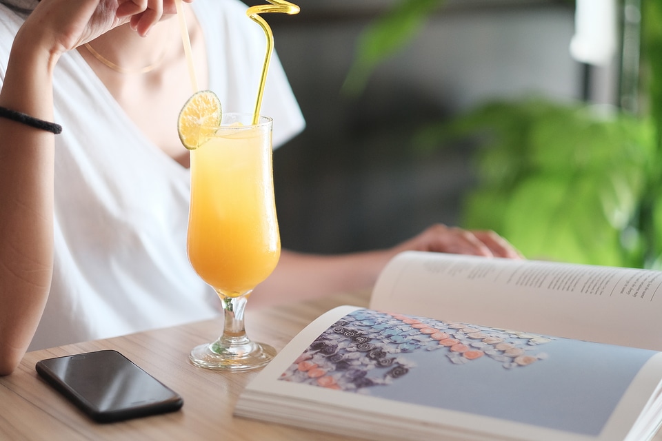 Woman Drinking Cocktail in a Cafe