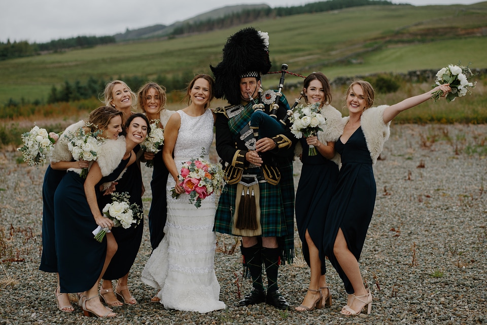 Beautiful Bride and Bridesmaids Posing with Bagpiper