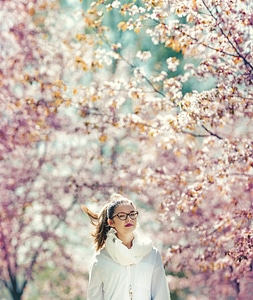 Girl Walking Among Flowering Cherries photo