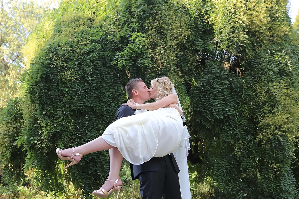 Groom holding bride photo