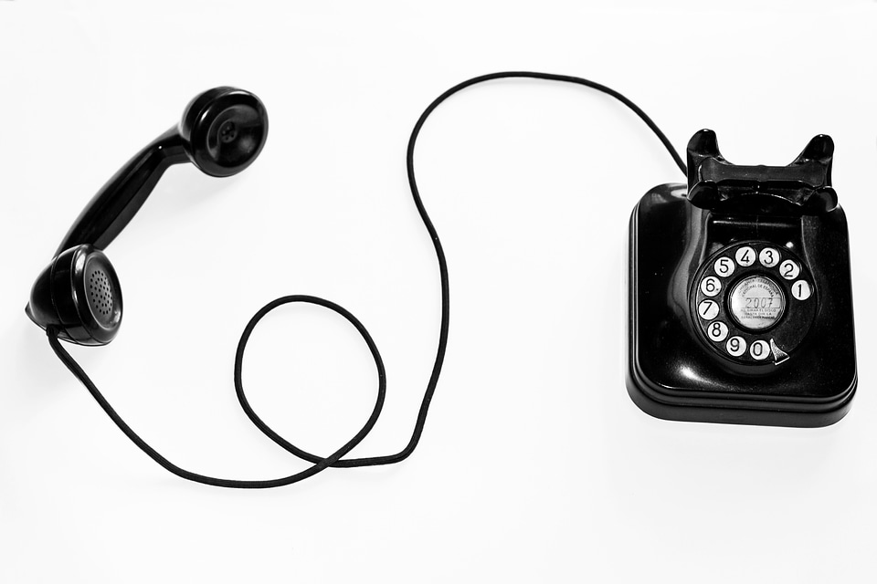 An Old Black Telephone with Rotary Dial Plate