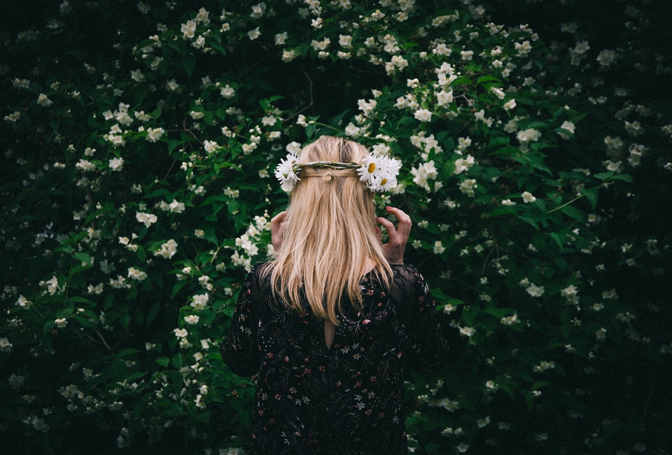 Woman Standing Back by Blooming Jasmine Bush