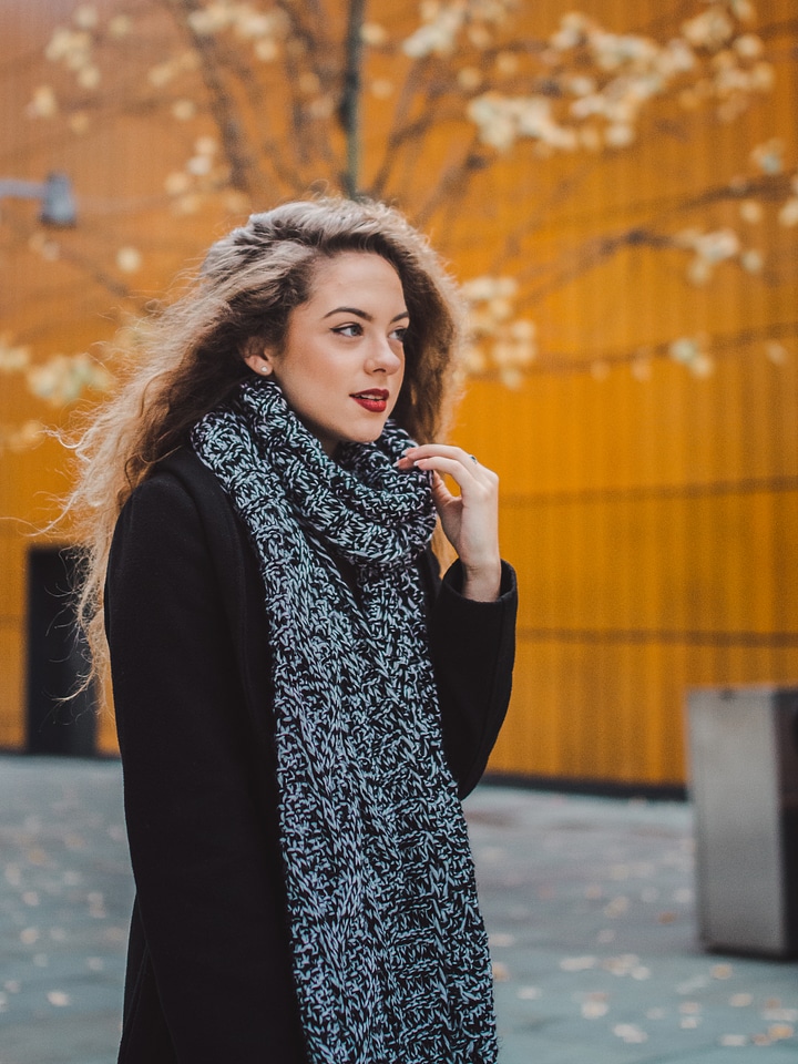 Long Haired Woman Walking at Autumn Street Wearing Black Coat and Scarf