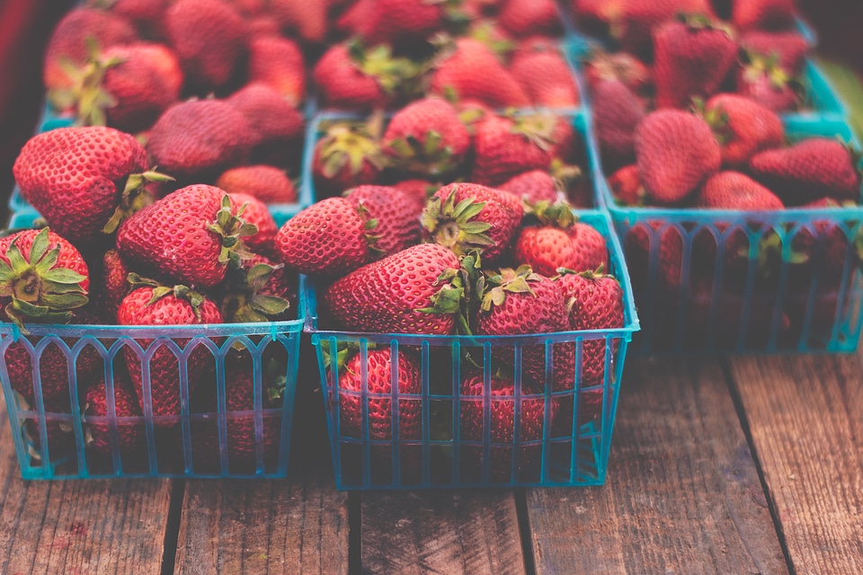 Fresh Strawberries in Boxes on Wooden Table