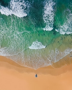 Aerial Drone Shot of Beautiful Sand Beach with Turquoise Sea Water photo