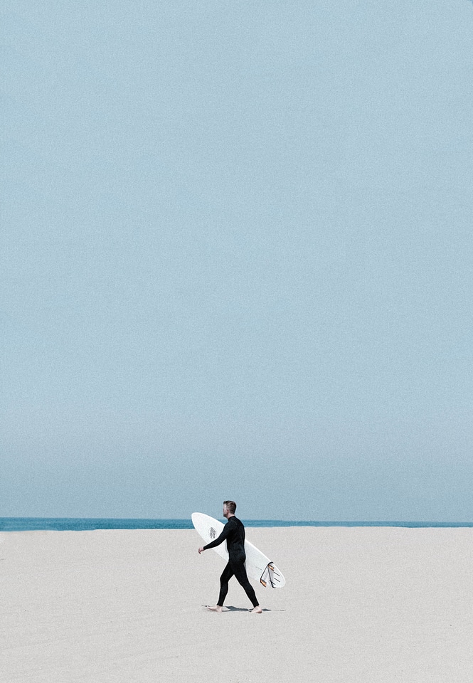 Surfer Walking on the Beach
