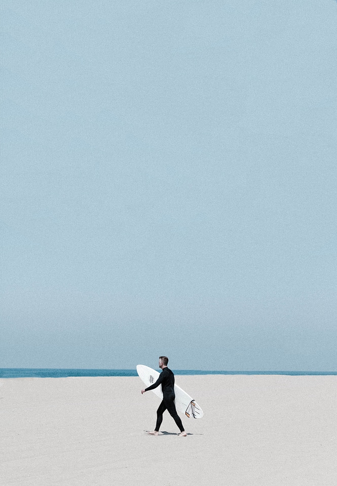 Surfer Walking on the Beach photo